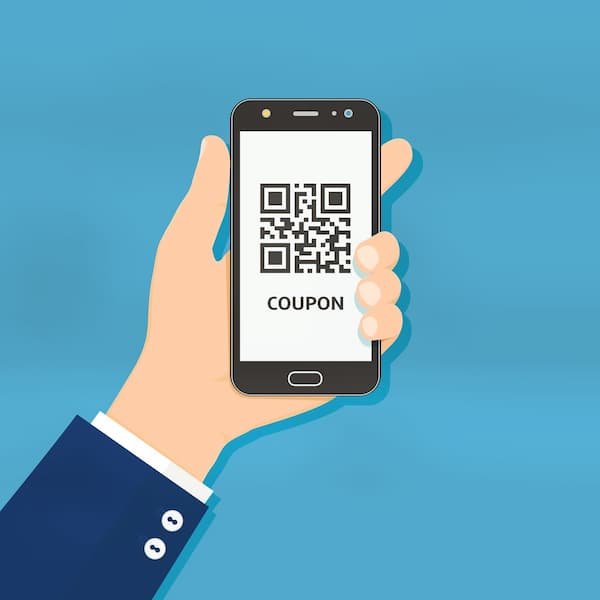 A hand holding a mobile phone that shows a coupon with a QR code on its screen.
